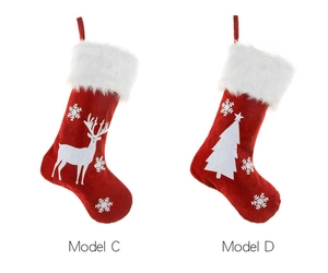 Detail view of red burlap Christmas stockings with white reindeer and tree embroidery