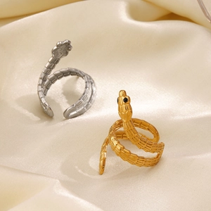 Vintage gold and silver stainless steel snake rings with scale textures on silk