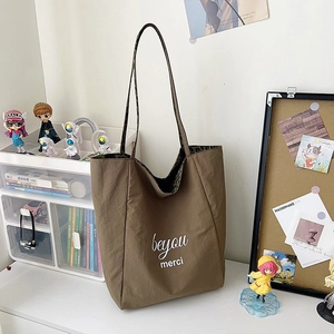 Large brown leopard print tote bag with beyou merci text on a white desktop