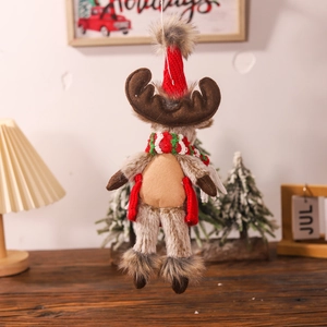 Close-up of a brown reindeer plush ornament with red knit hat and festive scarf