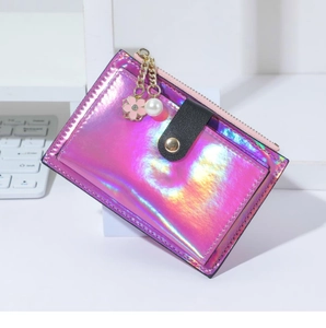 Pink holographic wallet detail with flower pearl charm and black strap closure