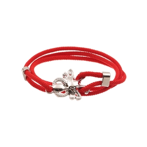 Detailed close-up of red braided rope bracelet featuring a silver octopus charm fastener