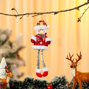 Detail of long-legged snowman ornament with red hat hanging on a Christmas branch