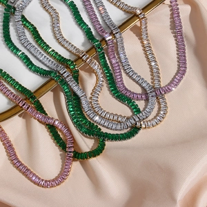 Macro view of baguette-cut zircon tennis necklaces in green, pink, and white crystal