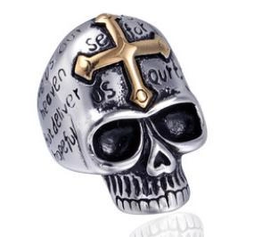 Detailed shot of silver punk skull ring with golden cross and bible verse engraving