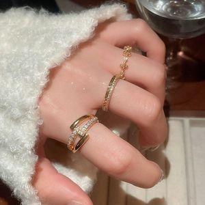 Macro shot of 18k rose gold plated rings with cubic zirconia worn on models finger