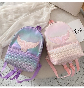 Detailed view of mermaid embroidery and fish scale texture on holographic backpacks