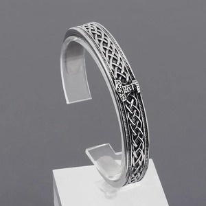 Detailed high relief engraving of Thor's hammer and Celtic knots on vintage silver cuff