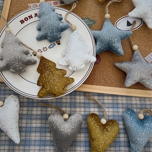 Detail of plush Christmas tree, star and heart fabric ornaments with wood bead hangers