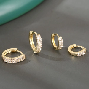 Close-up of gold-plated hoop earrings featuring micro-pave zirconia in two varying sizes