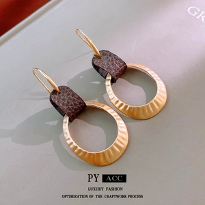 Vintage gold hammered metal oval hoop earrings with dark brown textured leather accents