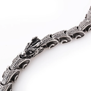 Macro shot of a retro silver 316L stainless steel dragon head and scale chain necklace