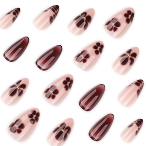 Short almond press-on nails set featuring burgundy cat-eye and floral designs