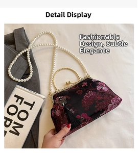 Detail of vintage floral embroidery handbag with pearl chain and silk tassel