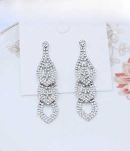 Close-up of sparkling bridal teardrop fringe earrings with white rhinestones
