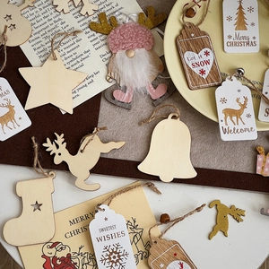 Flat lay of DIY Christmas wooden ornaments and plush gnomes for tree decoration