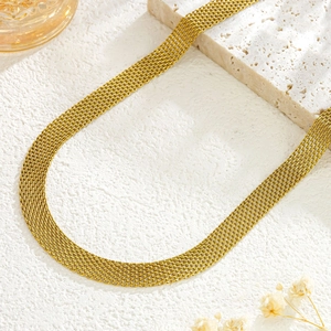 Elegant gold flat herringbone chain necklace styled with travertine stone and dried flowers