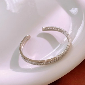 Detailed close-up of silver pave-set zircon stones on an open pig nose bangle bracelet