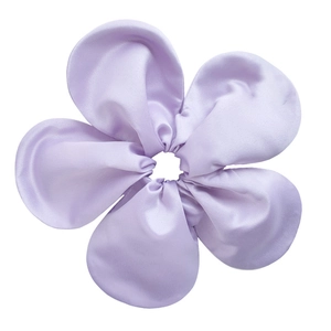 Macro shot of oversized lavender silk satin flower scrunchie with soft ruffled petals