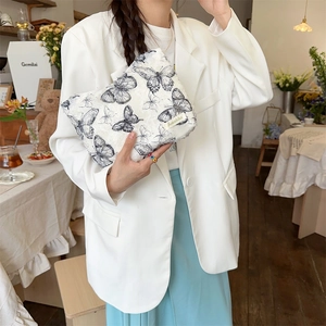 Lace butterfly makeup bag shown with model for size reference and elegant style