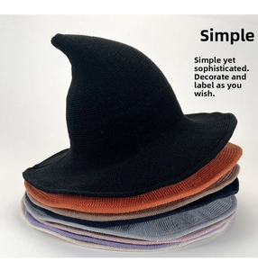 Detail of multi-color knitted wizard hats showing the thick ribbed texture and pointed design