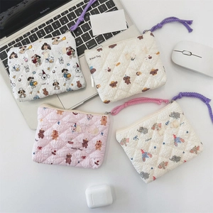 Quilted floral coin purses set with cute animal prints on a lifestyle office desk