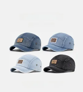 Detailed close-up of four washed denim baseball caps with leather patch and metal ring