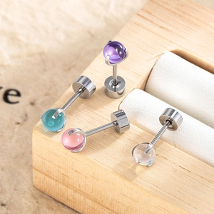 Titanium steel stud earrings with colorful dragon ball beads on a wooden display stand
