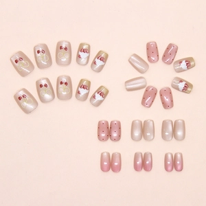 Close-up of sweet cherry and cat eye gradient press-on nails in pink and gold tones