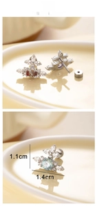 Detailed view of cubic zirconia cross star earrings with 1.1cm by 1.4cm dimensions
