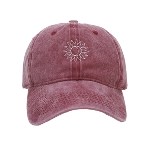 Detail of sunflower embroidery on vintage washed burgundy cotton baseball cap