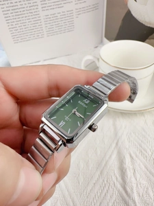 Close-up of vintage square emerald green watch with silver bamboo metal bracelet