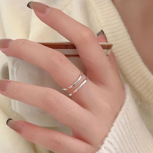 Detail of minimalist 925 silver double layer open ring worn on hand with cozy vibes
