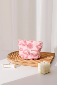 Détail de la trousse à maquillage peluche rose léopard avec texture douce en laine d'agneau