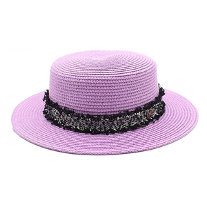 Lavender French vintage boater hat with tweed band and golden M emblem on flat top straw hat