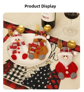 Christmas silverware holders featuring Santa, snowman, and reindeer on a festive table