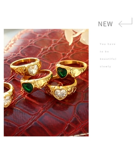 Detail of vintage heart-shaped gemstone ring with embossed gold-plated texture