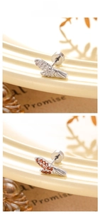 Detailed view of feather stud earrings with cubic zirconia in white and orange