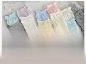 Detailed macro view of cotton ribbed socks with ruffled cuffs in various macaron colors