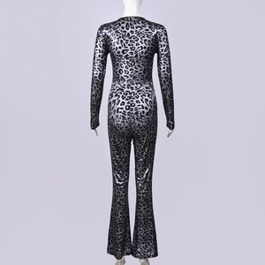 Macro detail of disco silver leopard print fabric texture on a long sleeve jumpsuit