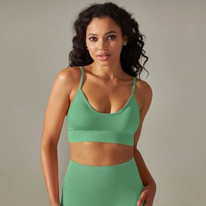 Detail of mint green seamless yoga set featuring ribbed high-waist leggings and sports bra