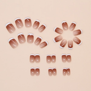Detail of short square gradient press-on nails with white French tips and glossy finish