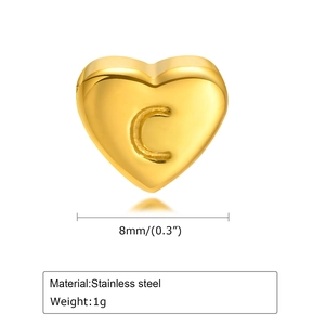 Detailed view of an 8mm gold heart charm with letter C engraving made of stainless steel