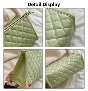 Detail view of the quilted stitching and metal zipper on the light green cosmetic bag
