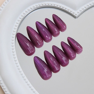 Purple galaxy cat-eye press on nails with long stiletto shape on heart mirror display