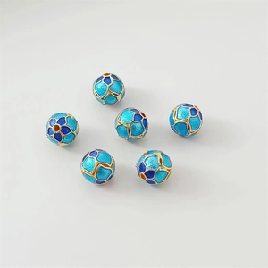 Detailed macro view of 6 blue and gold cloisonne watermelon enamel beads for DIY jewelry