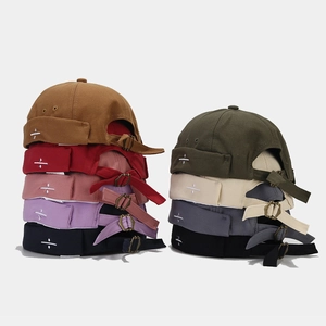Detail of docker hats with side symbol embroidery and adjustable metal buckle