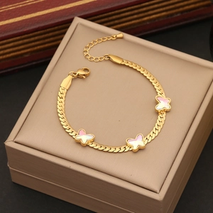 Elegant gold butterfly bracelet with snake chain design on a soft jewelry box