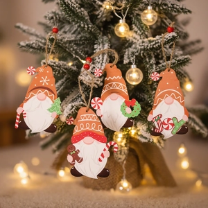 Set of 4 festive wooden gnome ornaments with gingerbread motifs on snowy Christmas tree