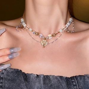 Double layered pearl and crystal heart necklace with gold diamond-encrusted pendant